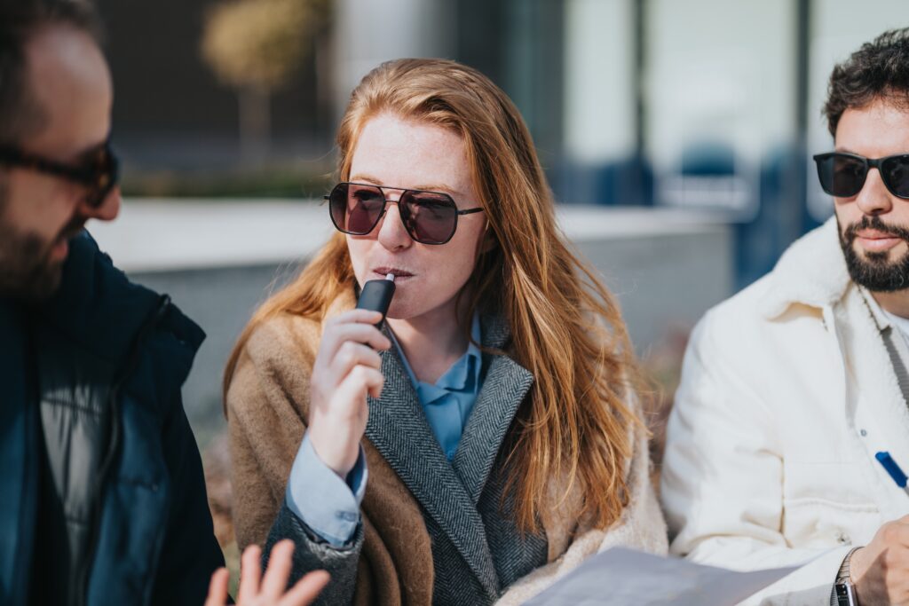 A young woman and her friends vaping and unaware of the dangerous effects of vaping.