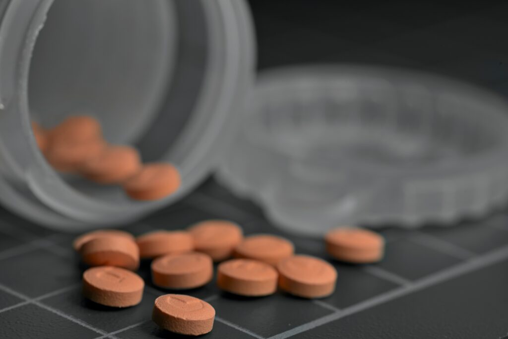 Quetiapine pills spilled over from the bottle that can potentially cause antipsychotic withdrawal symptoms.