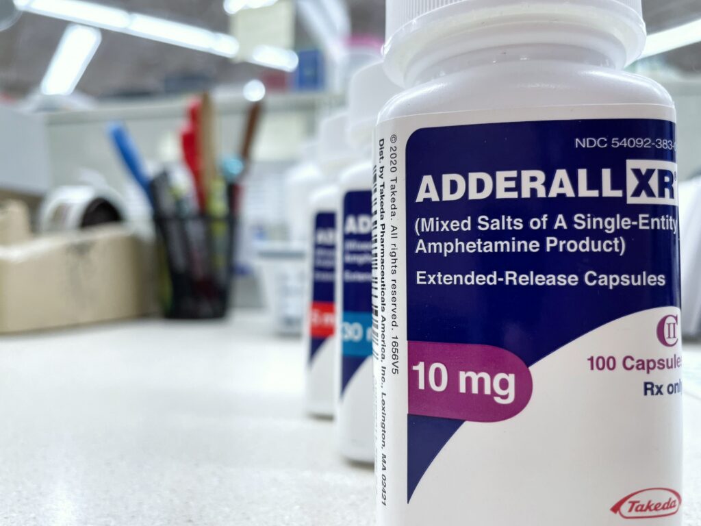 A pharmacy prescription bottle of Adderall representing the question asking can Adderall cause depression.