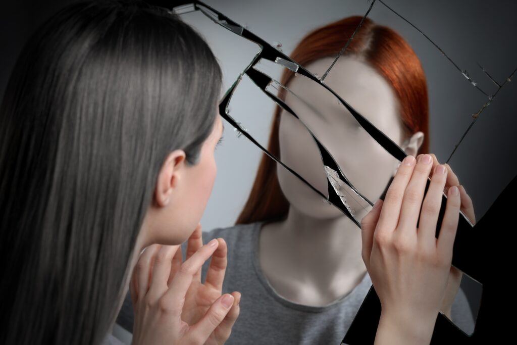 A young woman seeing things in the mirror wondering does alcohol make you hallucinate.