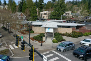 Street intersection with building in the center that it the outpatient center for Hotel California by the Sea