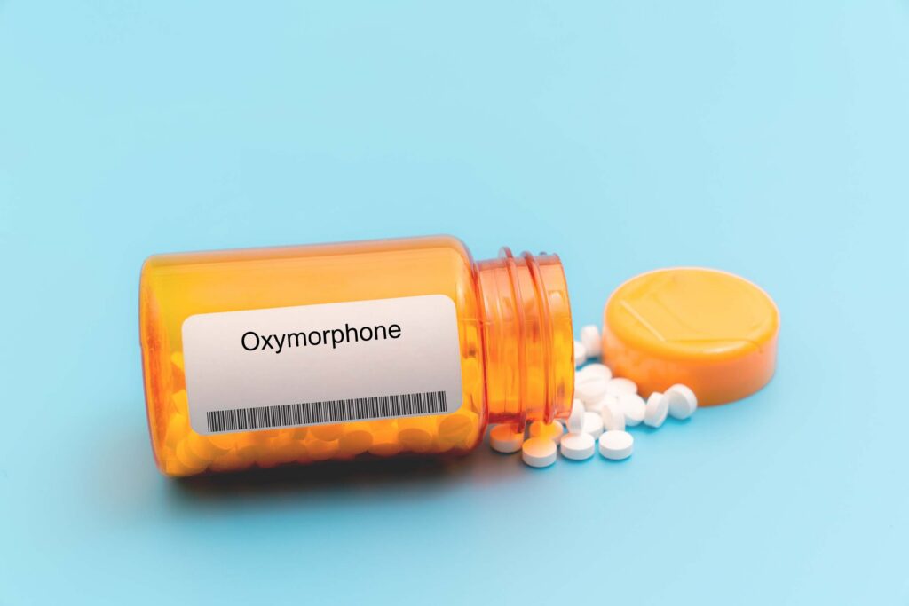 A spilled over orange pharmacy bottle of oxymorphone or the brand name Opana.