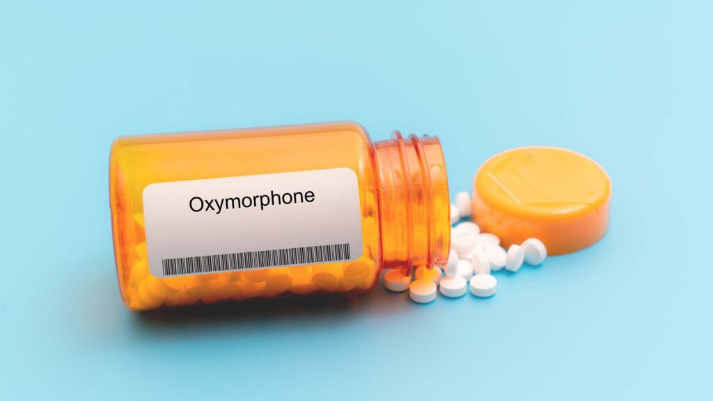 A spilled over orange pharmacy bottle of oxymorphone or the brand name Opana.