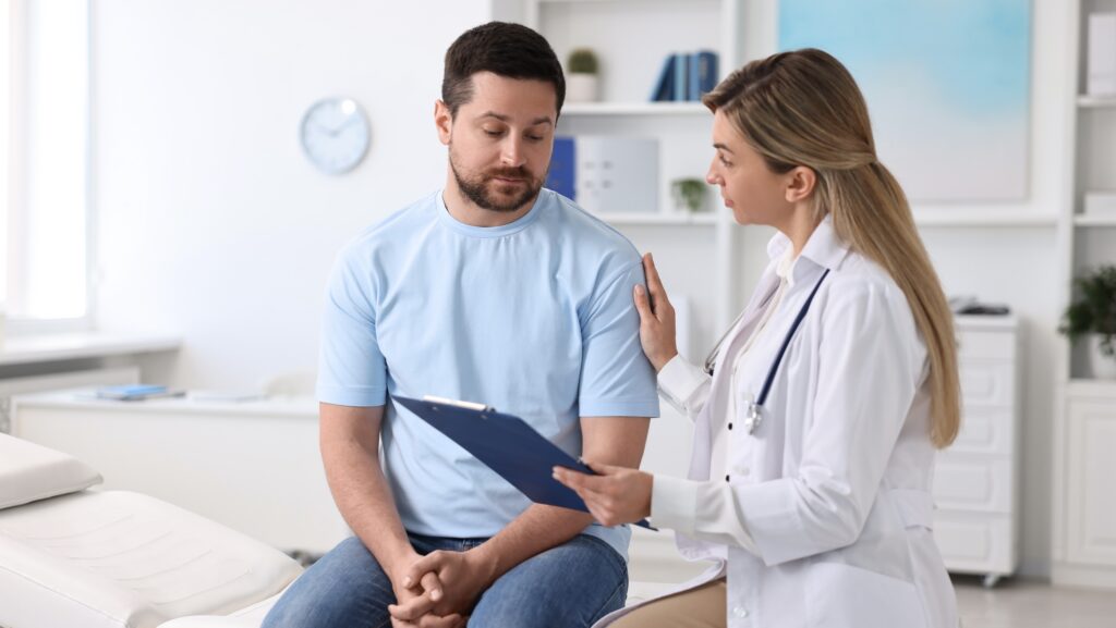 A man and his doctor discussing his care plan for hospital alcohol detox.