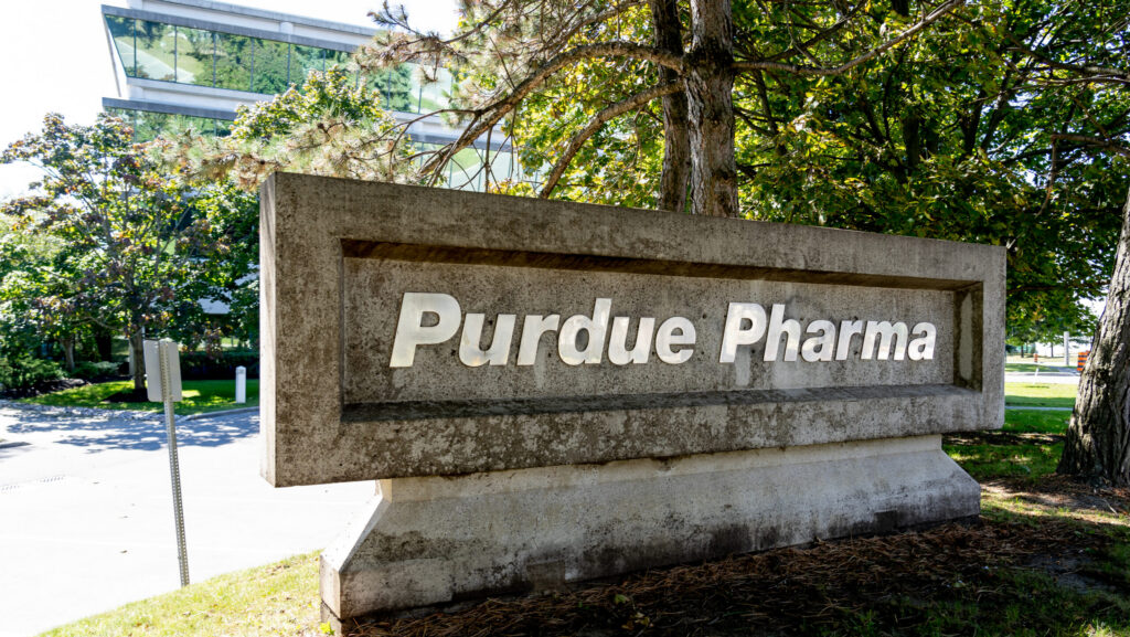 A building sign of Purdue Pharma represents the importance of the Purdue Pharma settlement.