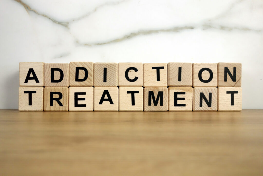 Block letters that spell out addiction treatment representing the importance of having an addiction treatment plan.