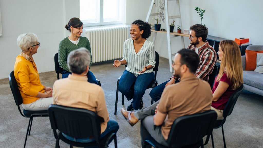 A group of men and women sitting in a circle for group therapy at an Orange County IOP.