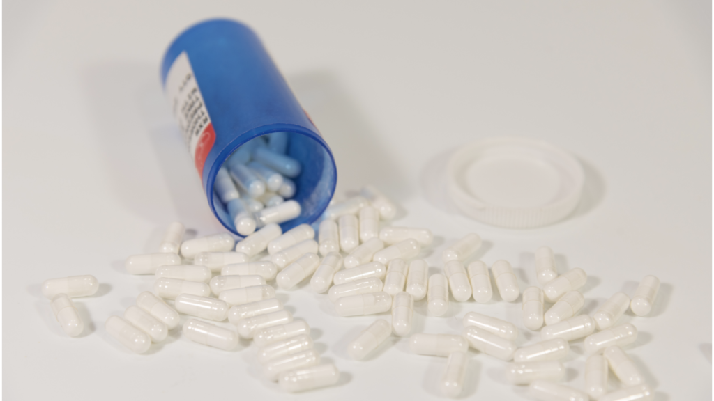 A bottle of naltrexone pills spilled over.