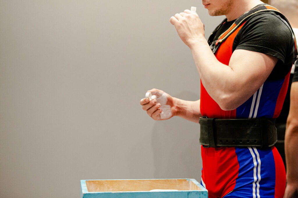 A male powerlifter about to inhale smelling salts before his competition begs the question of can you get addicted to smelling salts.