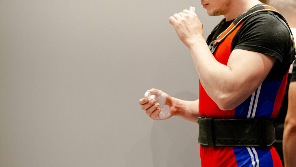 A male powerlifter about to inhale smelling salts before his competition begs the question of can you get addicted to smelling salts.
