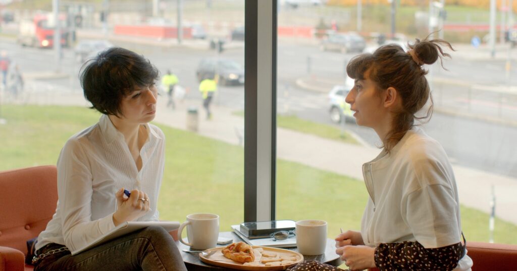 A woman in recovery talking to her sober coach about her plans after leaving residential treatment.