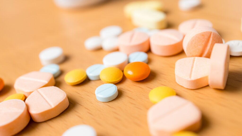 Various antidepressant pills on a table that can lead to symptoms similar to prozac withdrawals.